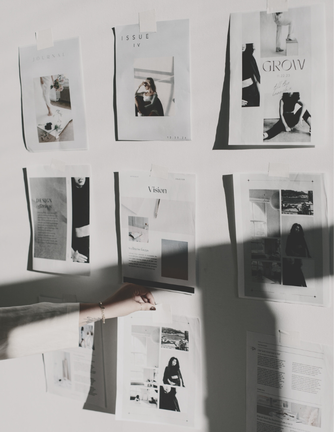 Editorial design concepts pinned to a wall